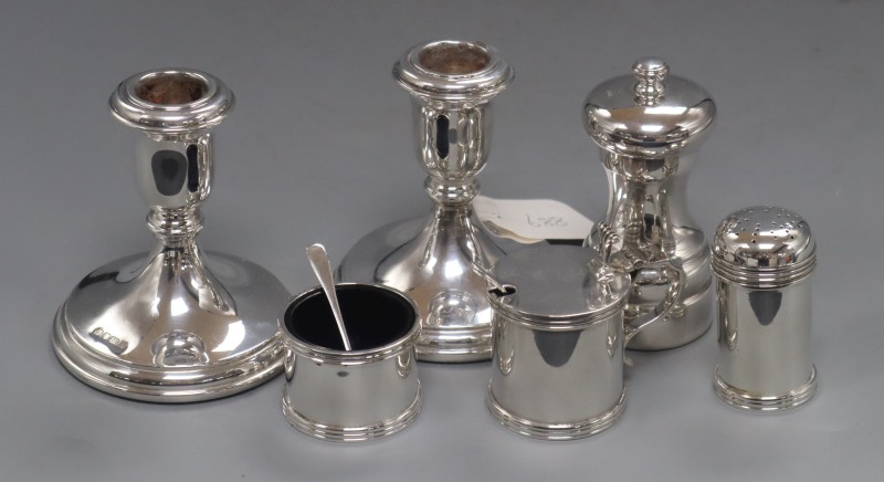 A pair of modern silver dwarf candlestick, Sheffield, 1994, 98mm, weighted, pepper mill and condiment set.